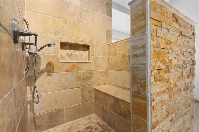 interior details featuring tiled shower