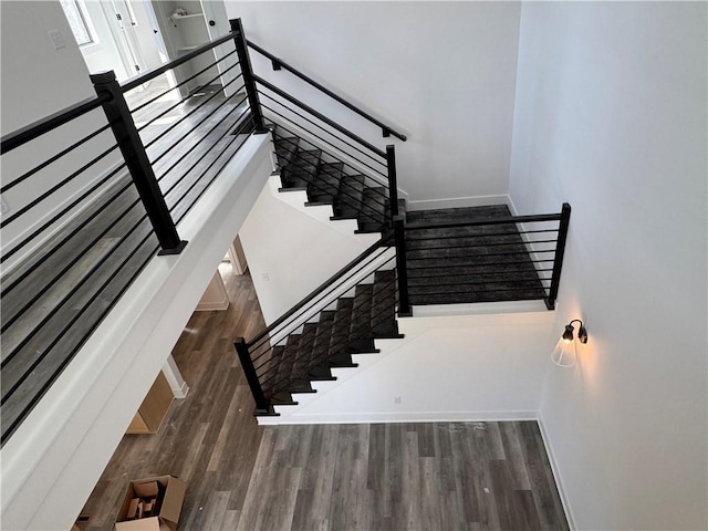 stairs featuring baseboards and wood finished floors