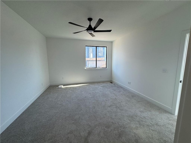 unfurnished room featuring carpet flooring, ceiling fan, and baseboards