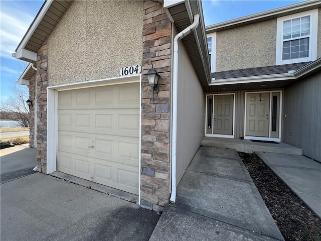 doorway to property with a garage