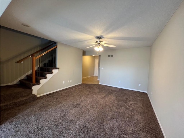 spare room featuring carpet flooring, a textured ceiling, and ceiling fan