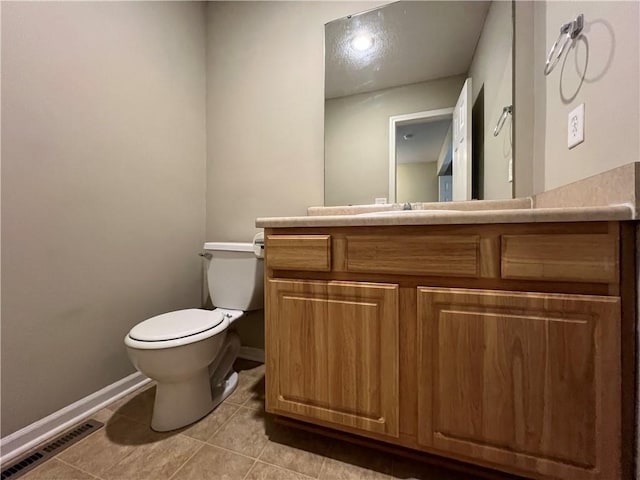 bathroom featuring vanity, toilet, and tile patterned flooring