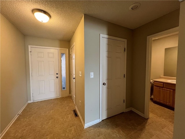 entryway with a textured ceiling