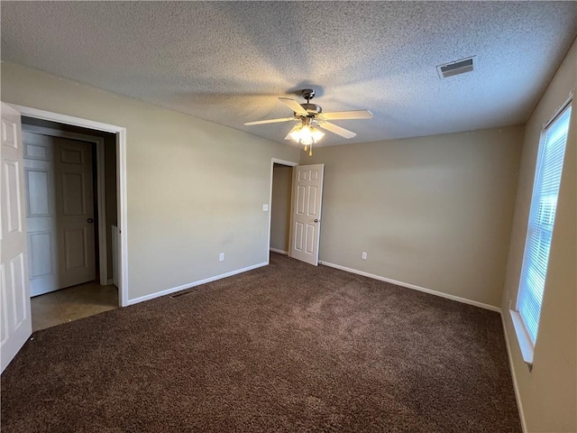 carpeted empty room with a textured ceiling and ceiling fan