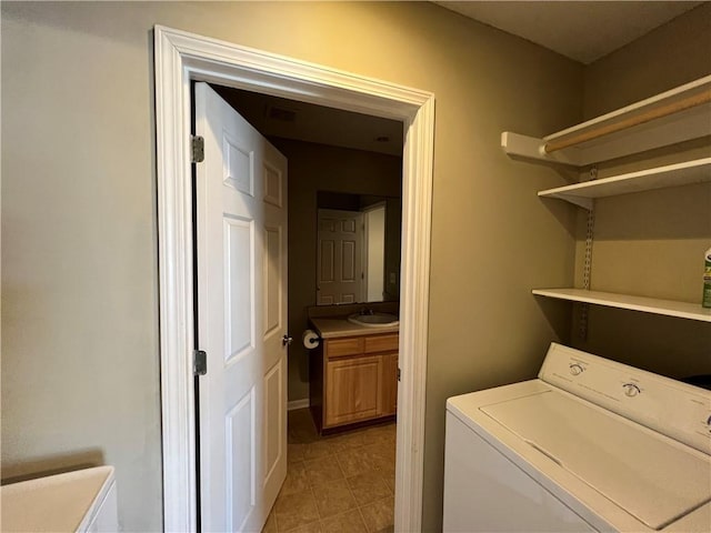 laundry area featuring sink and washer / dryer