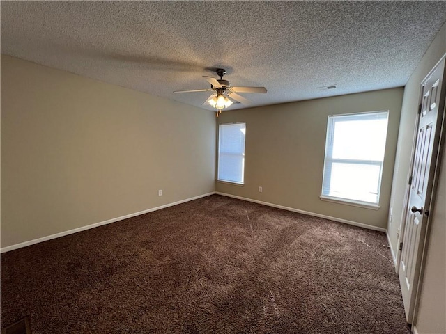 empty room featuring a textured ceiling, ceiling fan, and carpet