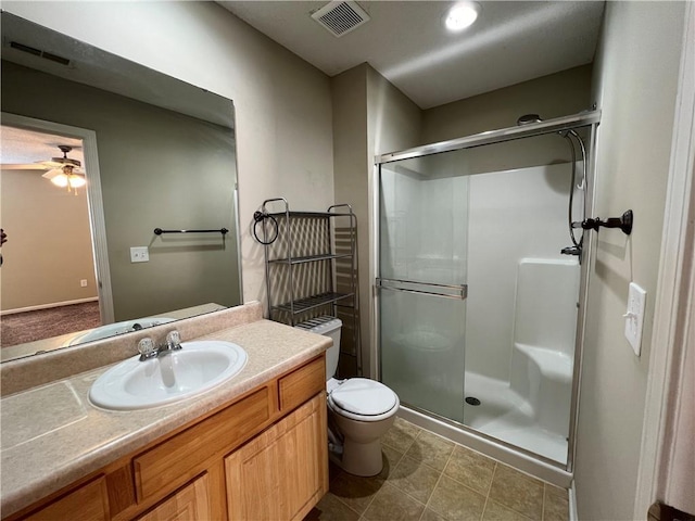 bathroom featuring vanity, ceiling fan, toilet, and walk in shower