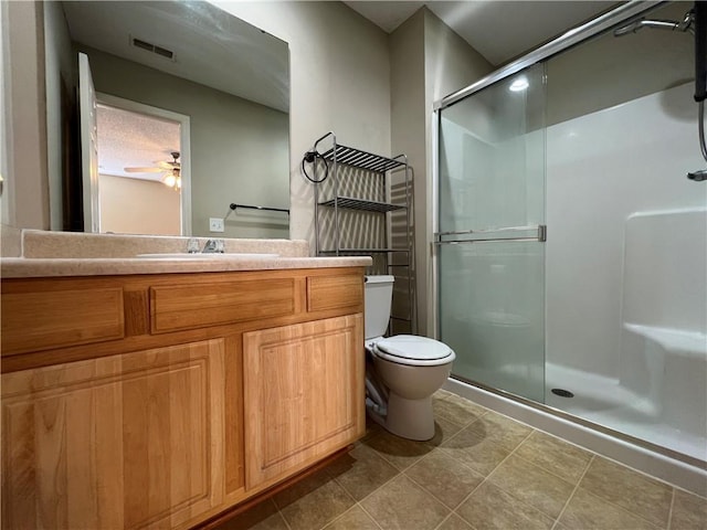 bathroom with walk in shower, vanity, and toilet