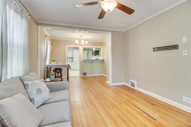 living room featuring crown molding, ceiling fan with notable chandelier, and hardwood / wood-style floors