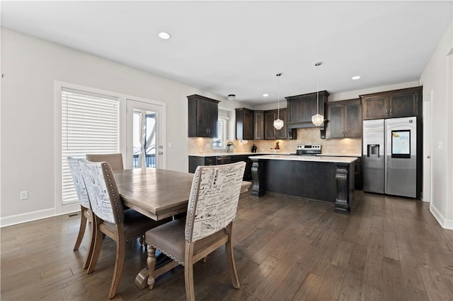 dining area with dark hardwood / wood-style flooring and sink