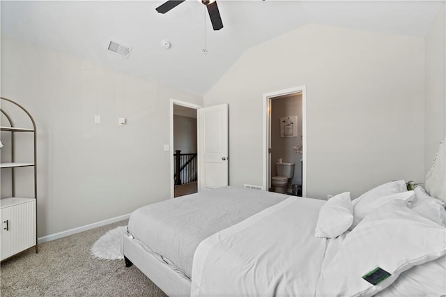 bedroom featuring vaulted ceiling, light colored carpet, ceiling fan, and ensuite bath