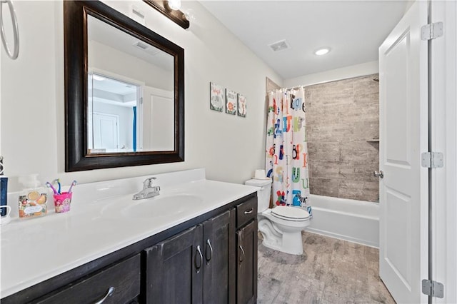 full bathroom with vanity, hardwood / wood-style floors, shower / tub combo, and toilet