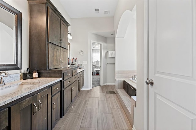 bathroom featuring a bathing tub and vanity