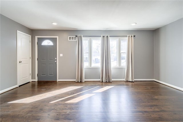 entryway featuring wood finished floors, visible vents, and baseboards