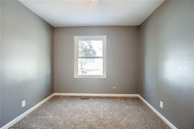 spare room with carpet flooring and baseboards