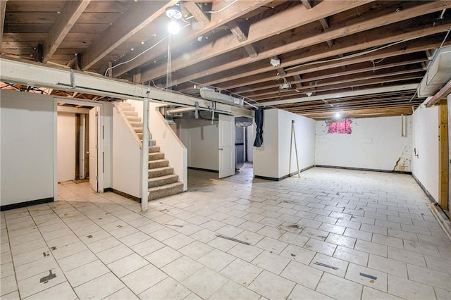 unfinished basement with baseboards and stairs