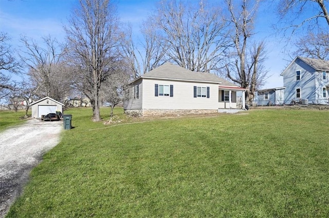 view of home's exterior featuring an outbuilding, a garage, and a yard