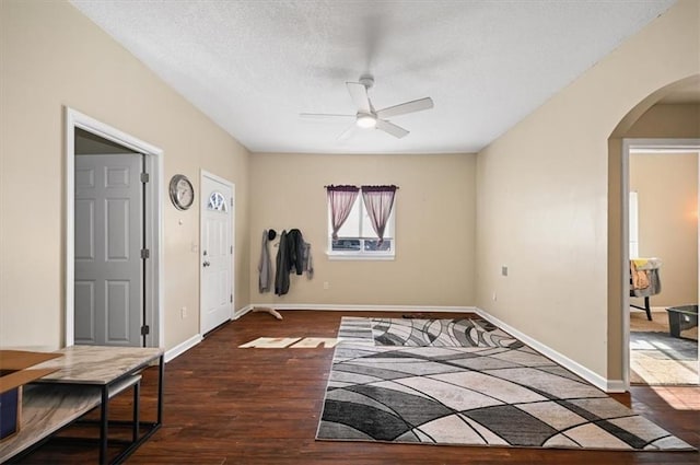 entrance foyer with ceiling fan, dark hardwood / wood-style floors, and a textured ceiling