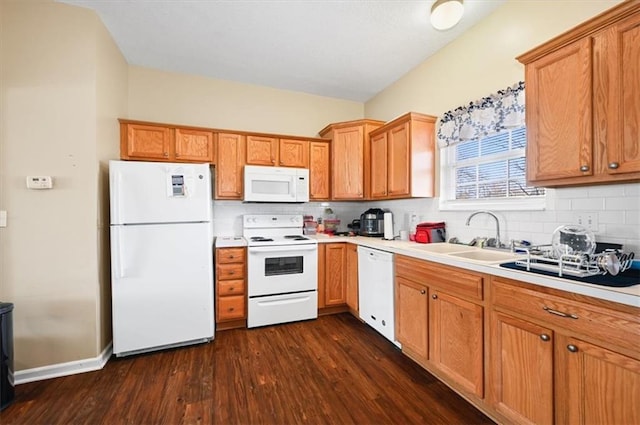 kitchen with tasteful backsplash, white appliances, dark wood-type flooring, and sink