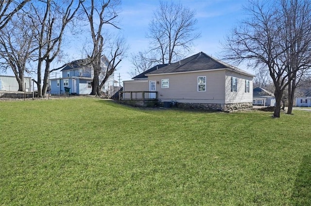 view of side of property with a lawn