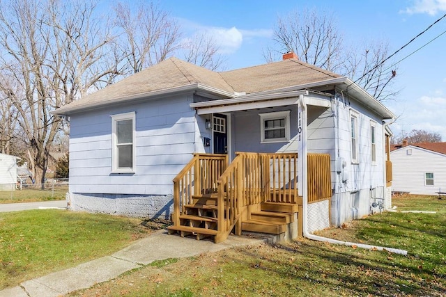 bungalow-style home featuring a front yard