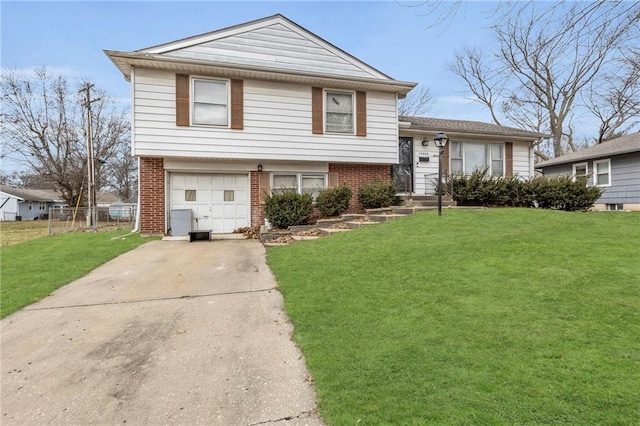 tri-level home featuring a garage and a front yard