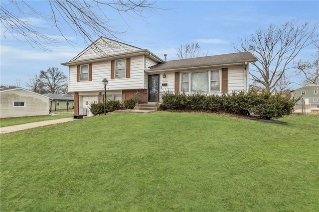 split level home featuring a garage and a front lawn