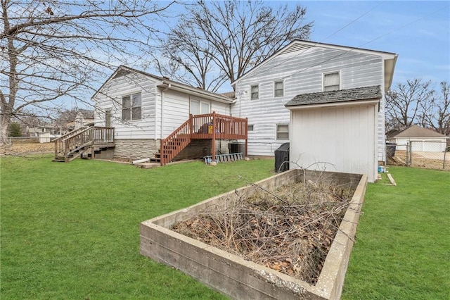 back of property with a wooden deck and a yard