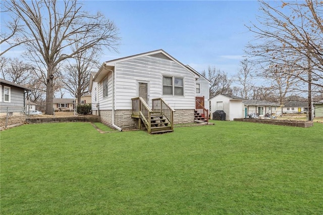 rear view of house featuring a lawn