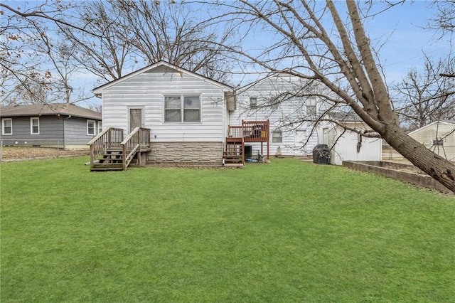 back of house with a wooden deck and a yard