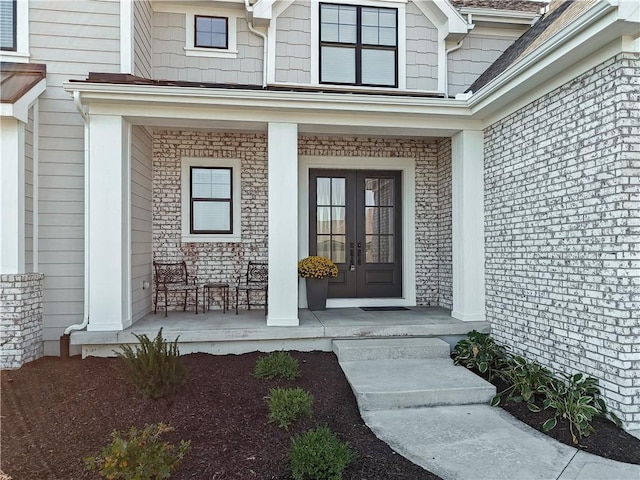 entrance to property with covered porch and french doors