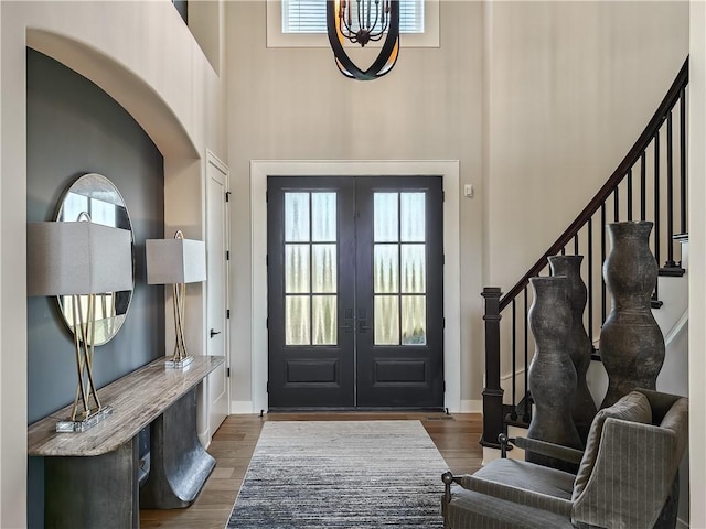 entryway featuring french doors, dark hardwood / wood-style flooring, and a high ceiling