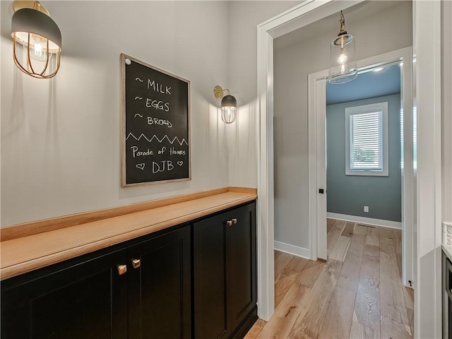 corridor with light hardwood / wood-style floors