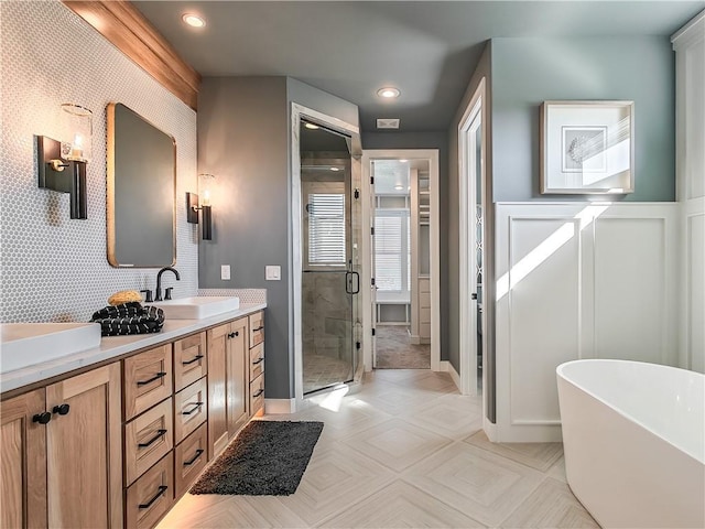 bathroom with independent shower and bath and vanity