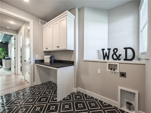 washroom with cabinets, washer hookup, and hookup for an electric dryer