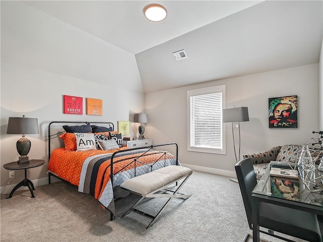 carpeted bedroom with lofted ceiling