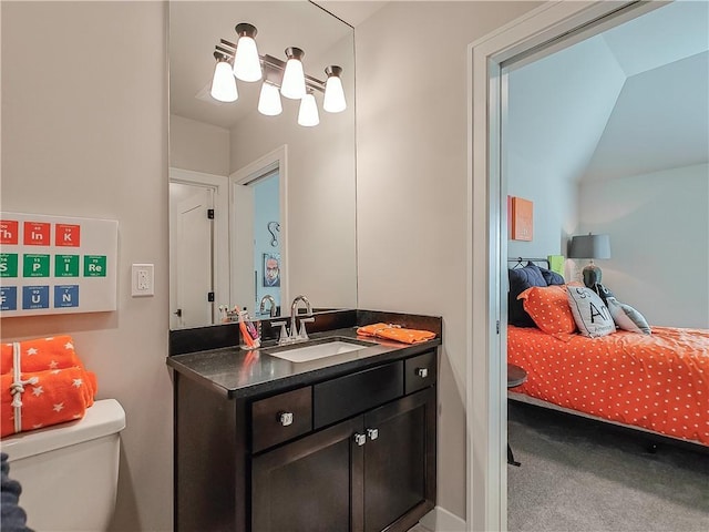 bathroom with vanity, vaulted ceiling, and toilet