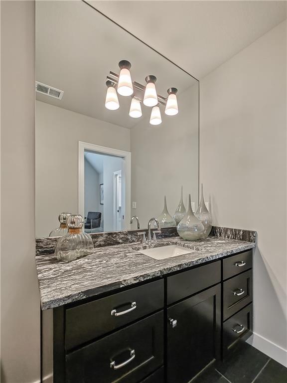 bathroom with vanity and tile patterned flooring