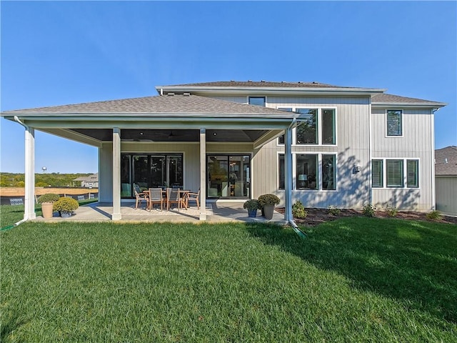 back of property with a patio and a lawn