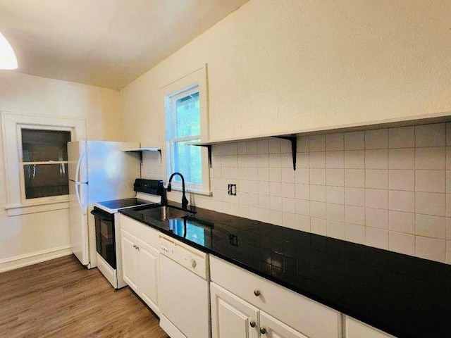 kitchen featuring sink, dark hardwood / wood-style floors, white dishwasher, electric stove, and white cabinets