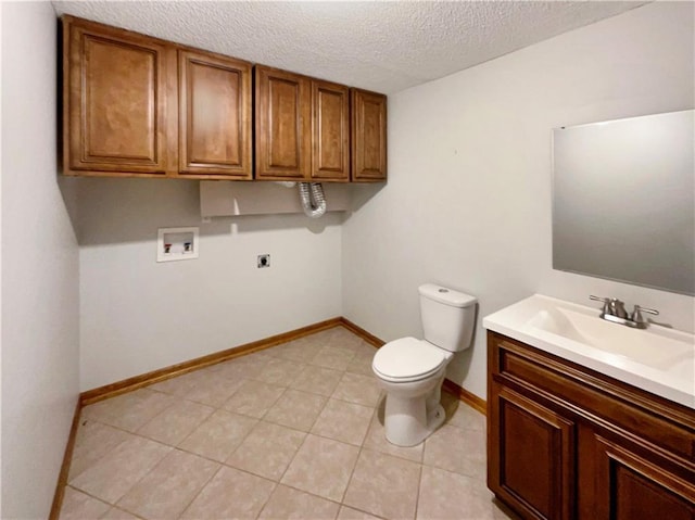 bathroom featuring vanity, tile patterned floors, a textured ceiling, and toilet