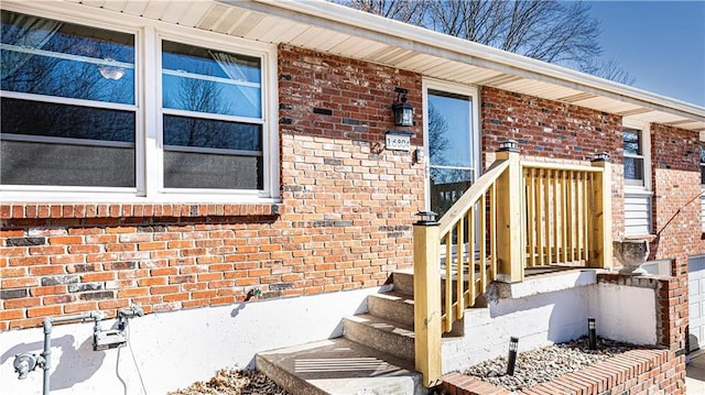 doorway to property featuring brick siding