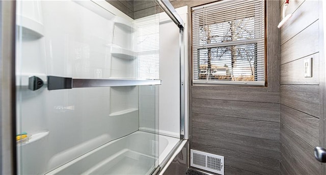 full bathroom with enclosed tub / shower combo and visible vents