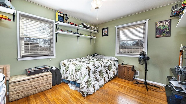 bedroom with light wood-type flooring and baseboards