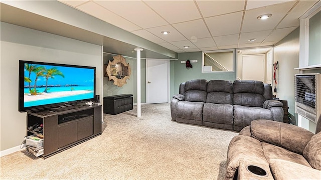 living area featuring a paneled ceiling, recessed lighting, baseboards, heating unit, and carpet