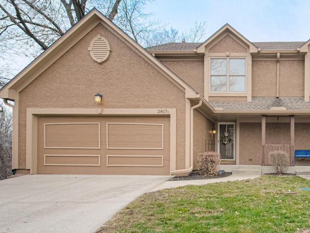 view of front of house featuring driveway, a shingled roof, an attached garage, a porch, and stucco siding