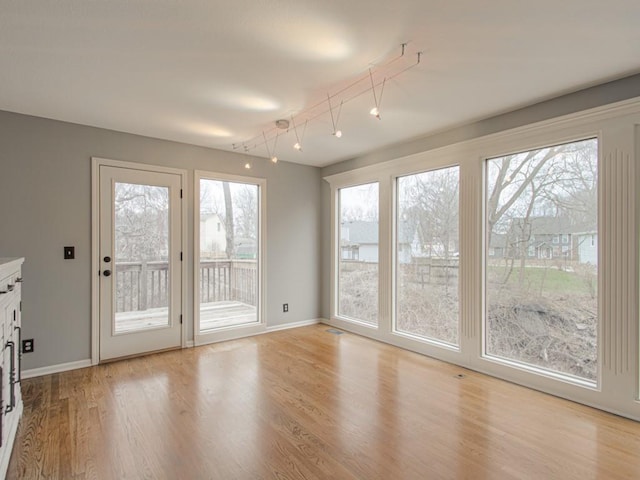 entryway featuring baseboards and light wood-style floors