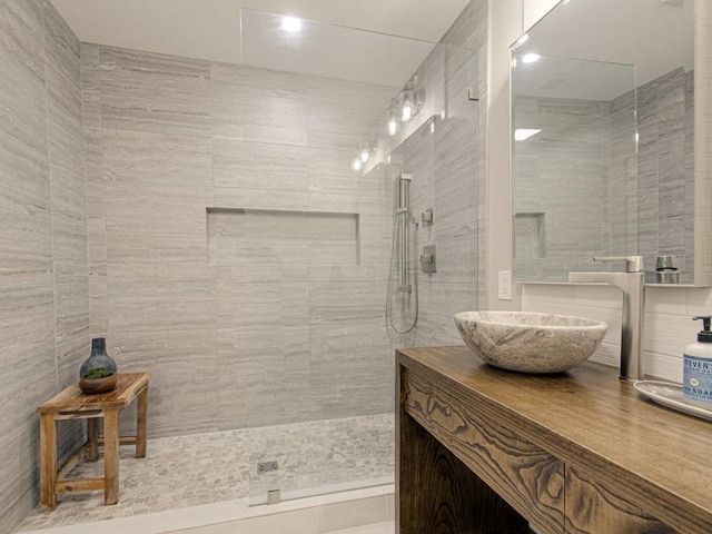 full bathroom featuring a walk in shower and vanity