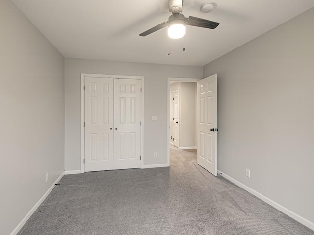 unfurnished bedroom with a ceiling fan, carpet, a closet, and baseboards