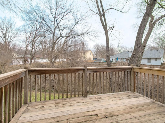 deck with a residential view and fence